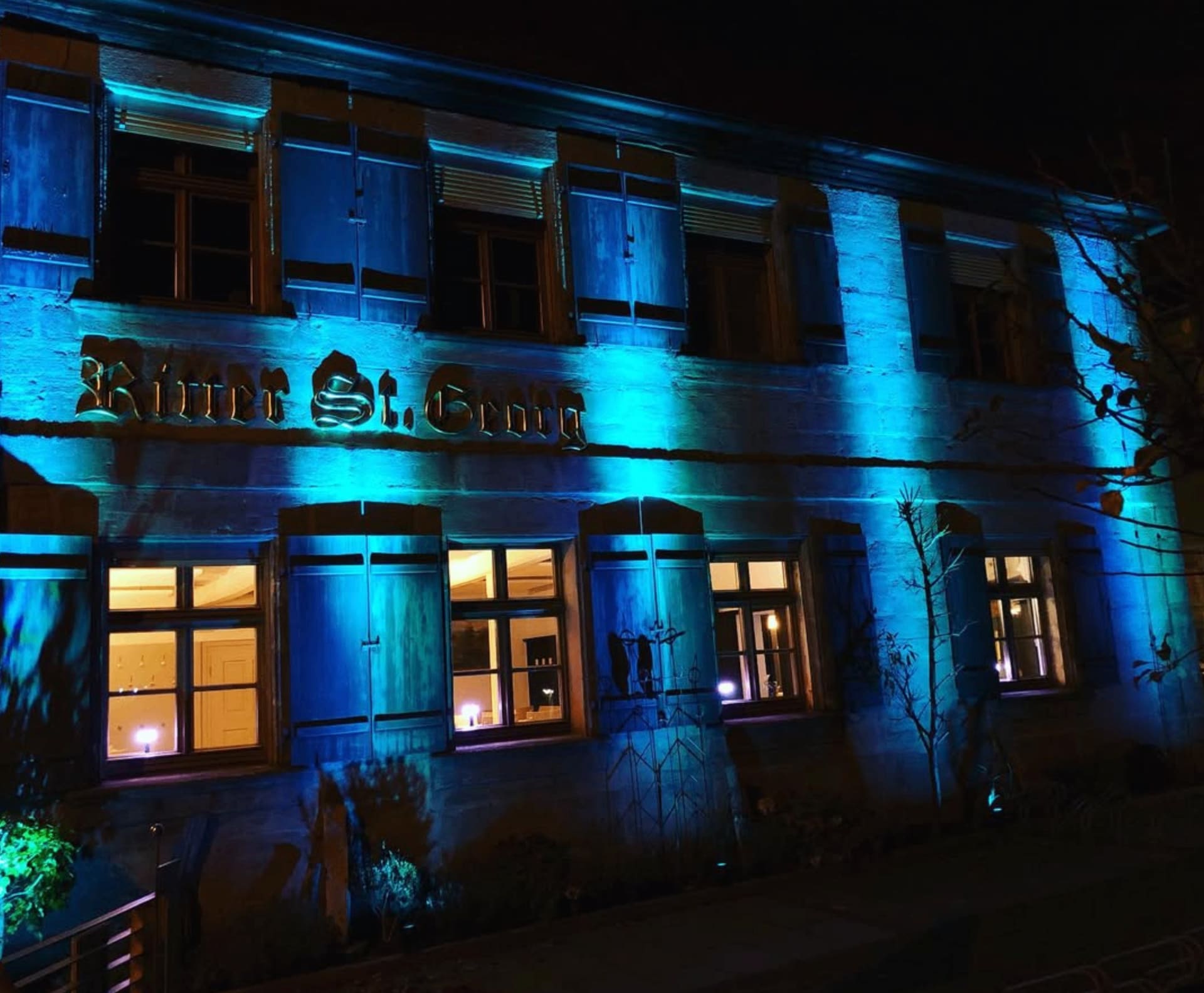 Gasthof Ritter St. Georg facade illuminated at night in Erlangen