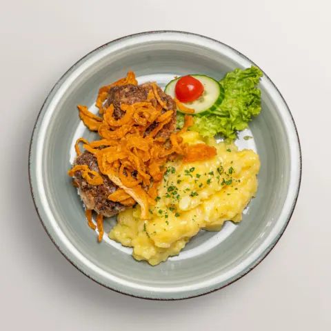 Bavarian meat patties with mashed potato and fried onions
